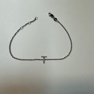 Elegant Sterling silver chain bracelet featuring a stylish T charm in diamonds